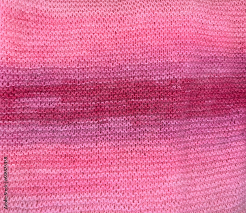 Pink knitted scarf. Seamless texture. Crochet, knitted background. Handmade warm winter clothing. Woolen scarf. Top view.