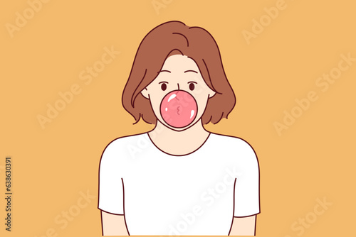 Woman inflates bubble of bubblegum and looks at screen, for concept idleness and indifference. Girl chews delicious bubblegum and is idle because of laziness or lack of motivation for self-development