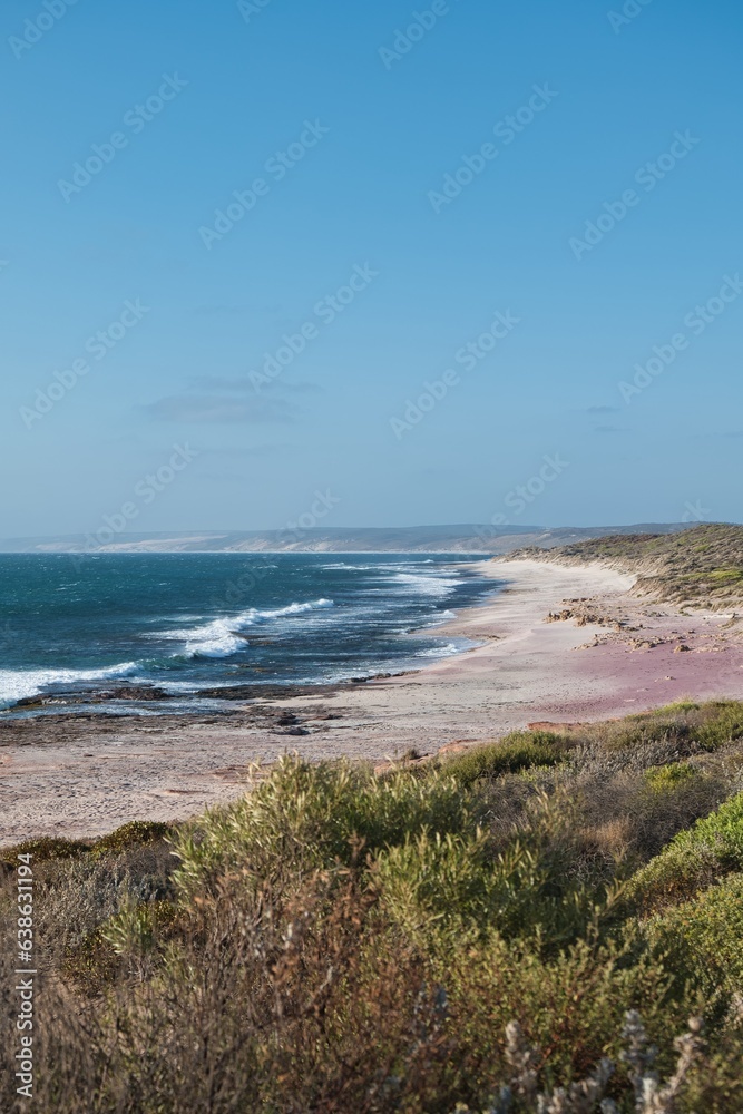 The wild and beautiful coastline of the Kalbarri National Park, Western Australia. Colorful bushland next to the deep blue ocean. Western Australia seaside landscape. Australian travel destination. 