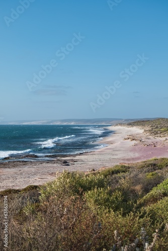 The wild and beautiful coastline of the Kalbarri National Park  Western Australia. Colorful bushland next to the deep blue ocean. Western Australia seaside landscape. Australian travel destination. 
