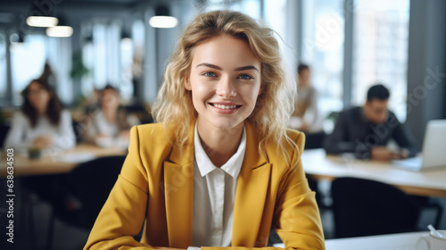 Executive businesswoman smiling while sitting at desk in fashionable office.