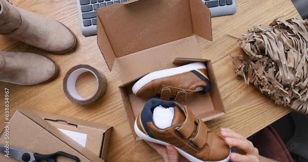selling online, internet store owner, small business entrepreneur working at home office and packing shoe order parcel for delivery