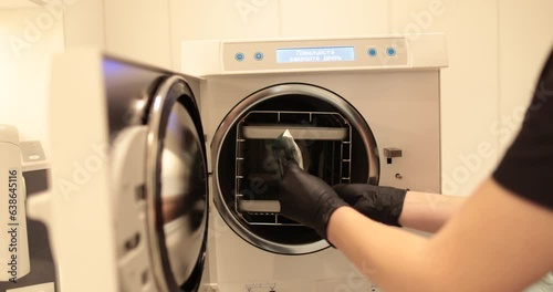 Disinfection of dental instruments in an autoclave. The process of using an autoclave to disinfect medical instruments. photo