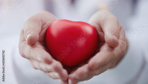 Fototapeta Naklejka Na Ścianę i Meble -  Doctor holding a heart in his hands, close-up