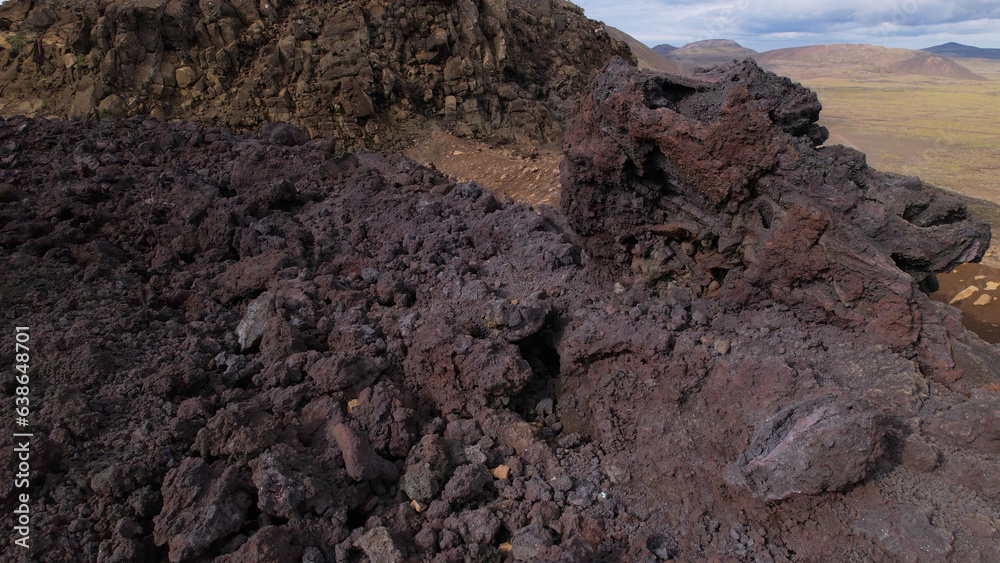 View of cracked lava crust or ingenious rock and steam cooled down from the 2021 eruption of Fagradalsfjall volcano in Geldingadalir Valley on Reykjanes Peninsula in Iceland.