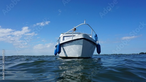 Motor boat sailing on the water. Cruiser moving with diesel as fuel and recreation is in leisure. Sailing rivers and lakes as a holiday residence.
