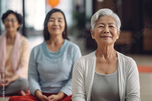 A group of Asians of different ages at a yoga class. Older woman at the training. Concept of healthy lifestyle.