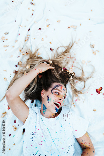 Portrait of a young woman covered in paint