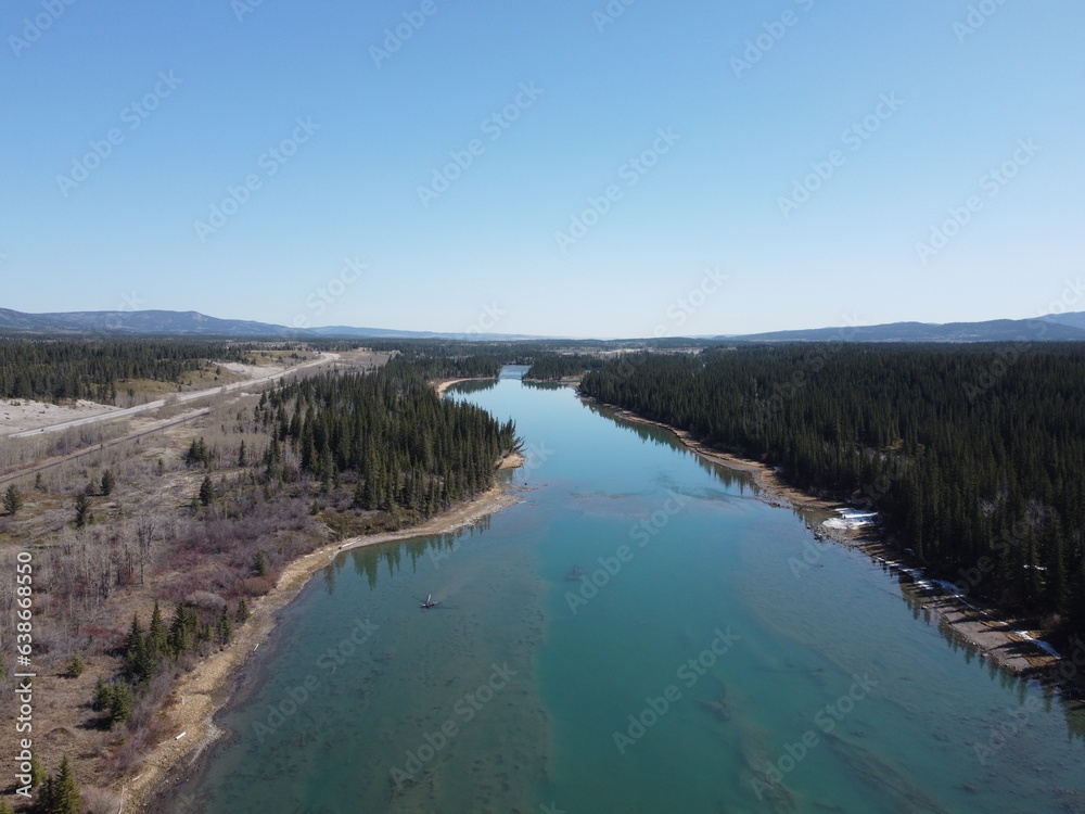 Aerial view of countryside in Alberta with river and mountain at distance