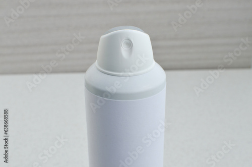 Close-up of spray deodorant with white label, conveying concepts of hygiene, 24 and 48 hour protection and fragrance. Representing the importance of protection and personal well-being. photo