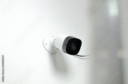 Watchful look of white security camera, offering security and protection from possible threats.