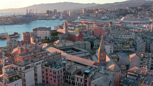 Golden hour aerial view over buildings of historic Porto Antico in Genoa, Italy photo