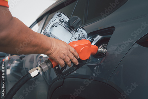 Handle fuel nozzle to refuel the car. Close up