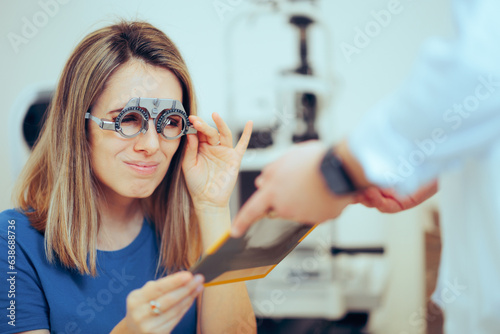 Patient Wearing a Trial Frame Squinting for an Eyesight Test. Doctor consulting a patient in ophthalmology clinic
 photo