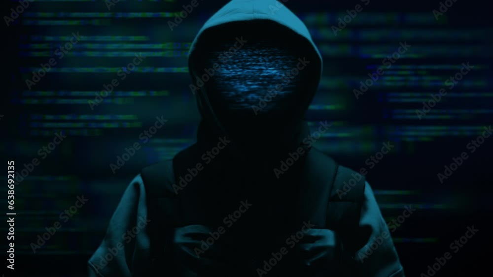 Computer hacker with hoodie and glitch face. Computer abstract digital code at the background. Darknet fraud and cryptocurrency bitcoin concept. Cybersecurity and data protection in social network