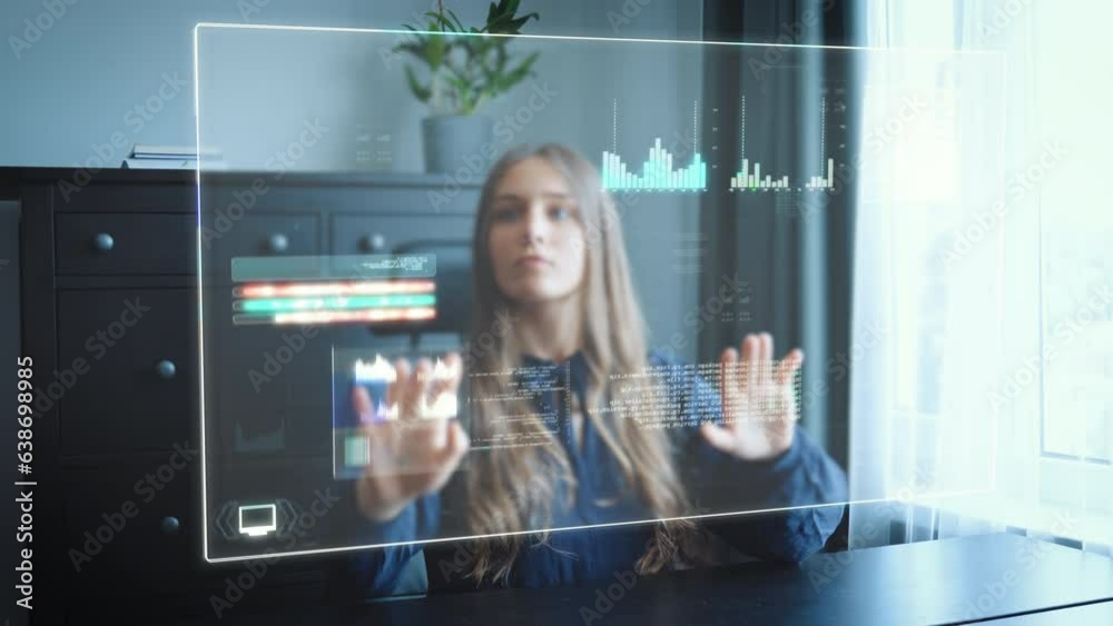 Business woman in home office works on futuristic HUD hologram screen and pushes around tables, graphs and statistics via gesture control