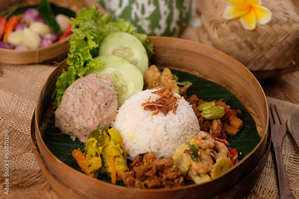 Nasi Berkat Pekalongan. is rice with side dishes of fried chicken, stir