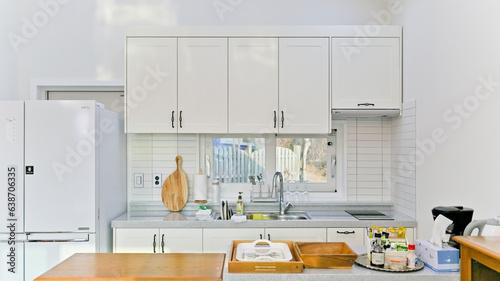 Well-organized Airbnb home white interior kitchen