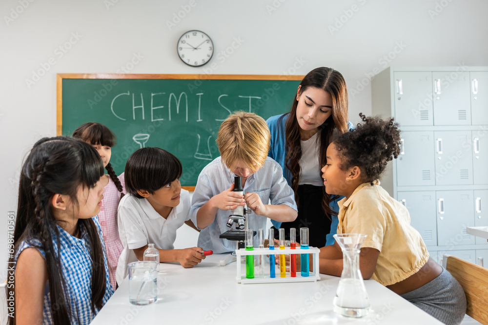 Adorable student learn with teacher in classroom at elementary school. Adorable student learn with teacher in classroom at elementary school.