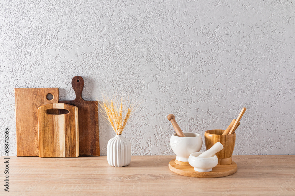 Environmentally friendly kitchen utensils and utensils in the kitchen interior on a wooden countertop. front view. Eco style. concrete wall. Environmentally friendly kitchen utensils and utensils in the kitchen interior on a wooden countertop. front view. Eco style. concrete wall.