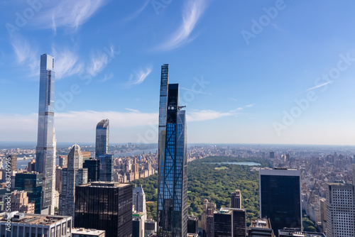 Vibrant urban skyline with towering skyscrapers and impressive architecture seen from Top of The Rock in New York. View on the Central Park from above. Hudson river on the side. Modern and lively city