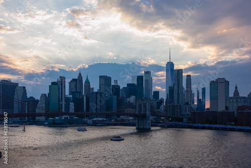 Urban sunset vistas on Brooklyn Bridge with city skyline in back seen from Manhattan Bridge near East Broadway, Chinatown, New York City, USA. Scenic view of modern metropolis with skyscrapers