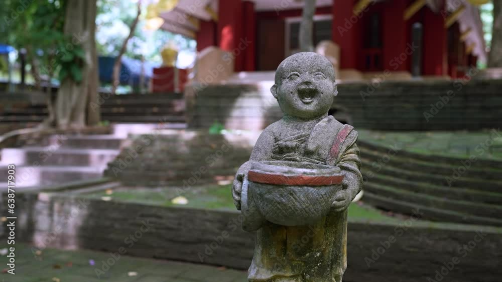 Sculpture of Buddhist Monk holding alms bowl.
Sculpture of Buddhist Monk holding alms bowl.