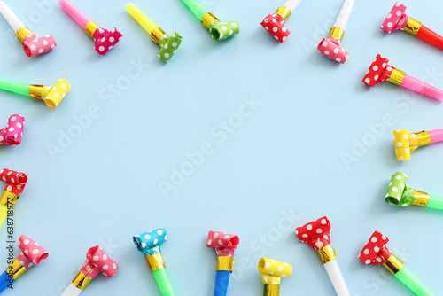 Collection of colorful party blowers on blue background. Concept of party or celebration