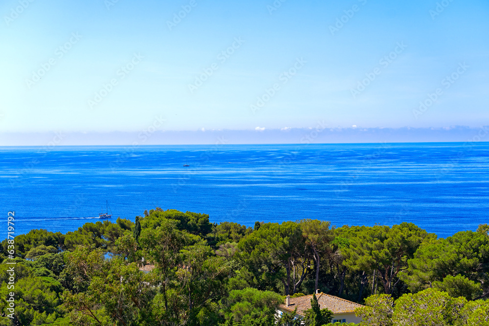 Aerial view of Mediterranean Sea seen from viewpoint of village of Giens with sailing boats in the background on a sunny late spring day. Photo taken June 10th, 2023, Giens, Hyères, France.