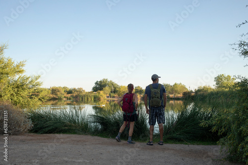 Couple on nature trail looking at lake