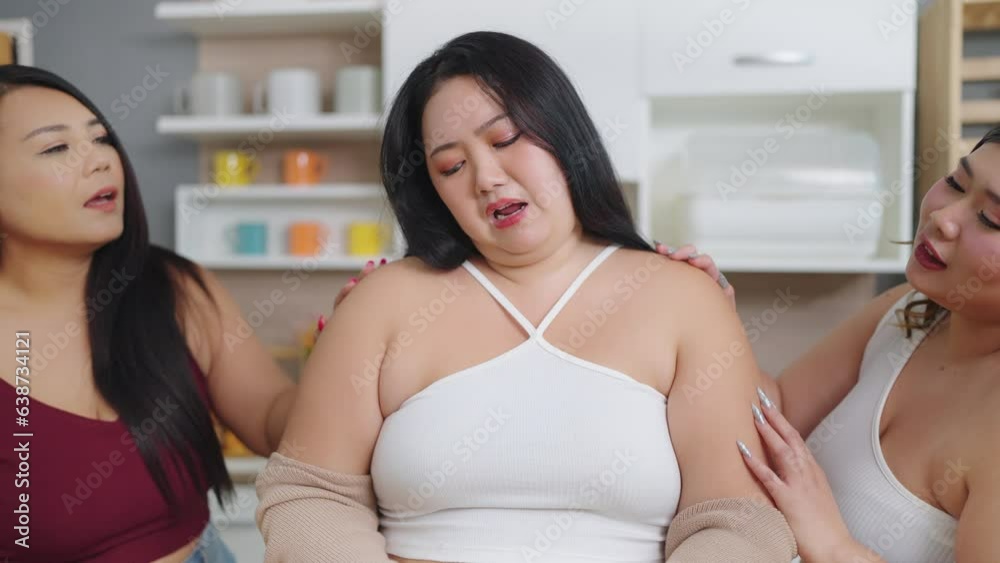 Group of cheerful chubby women friends feeling sad while cooking, preparing salad together in kitchen room. Group of chubby women friends feeling sad while diet. Eating healthy food concept