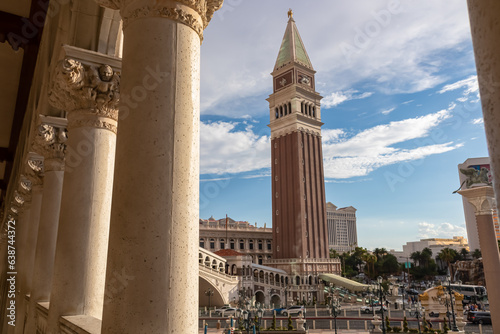 Scenic view of replica bell tower of luxury hotel Venetian seen through majestic white stone pillars on the Las Vegas Strip, Nevada, USA. Gambling, party, freedom and no limits concept