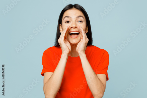 Fotografija Young latin woman she wear orange red t-shirt casual clothes scream sharing hot news about sales discount with hands near mouth isolated on plain pastel light blue cyan background