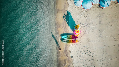 Kayaks are seen from above on a beach