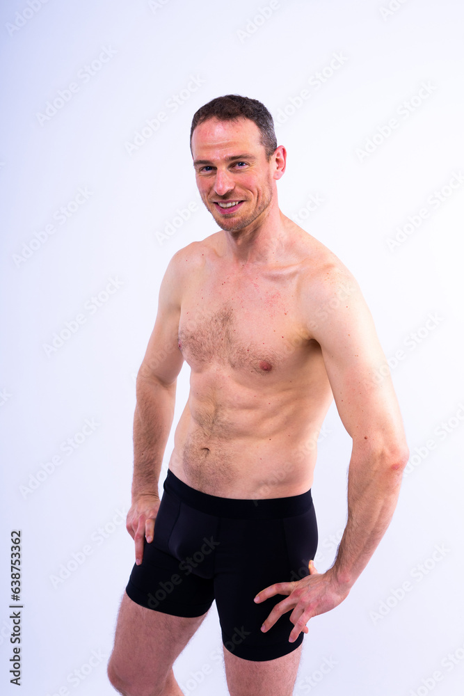 Man athlete isolated on black, red, white background. Fitness motivation.