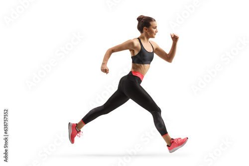Full length profile shot of a fit young woman running