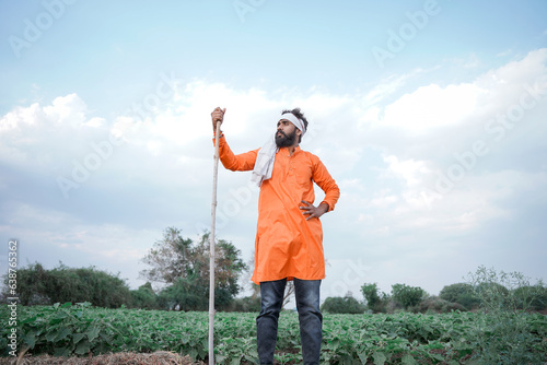 Young Indian farmer standing at Agriculture field