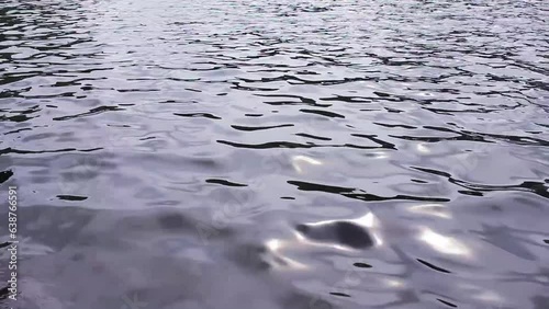Surface of a river peacefully flowing through stepping stones at Woldaecheon in Jeju Island, South Korea