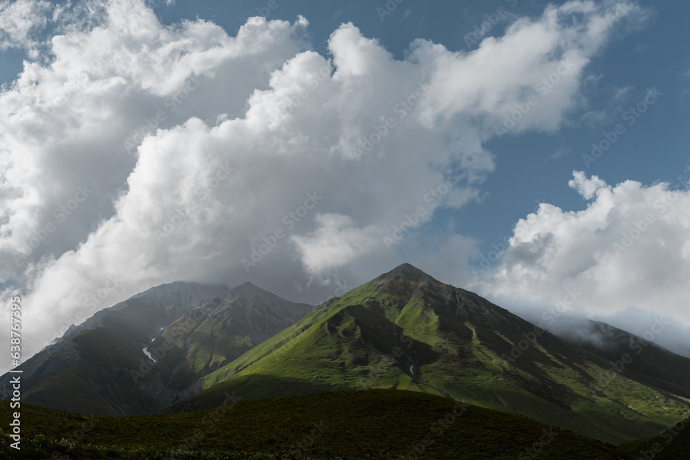 summer mountain landscape. clouds over the peaks