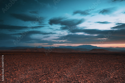 sunset over the desert with cloudy skies