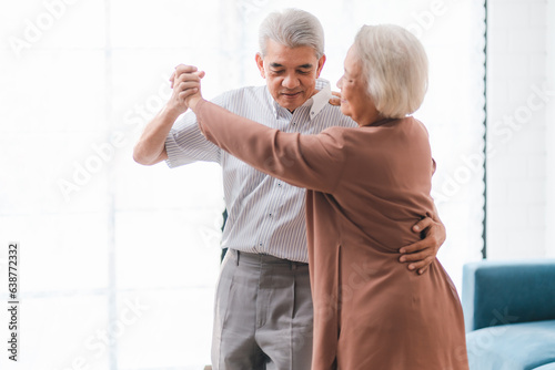 Asian happy senior couple having fun and relax dancing together at home, love, romantic elderly mature person or husband and wife lifestyle, aged retirement man and woman family are smiling to dance