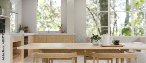 Fotografering Copy space on a minimal wooden dining table in a minimal Scandinavian kitchen