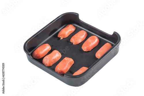 Sliced red sausages in a plate on a white background