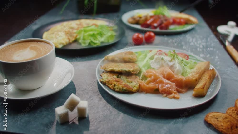 Served restaurant platter of salmon and scrambled eggs on a plate with smoke Served restaurant platter of salmon and scrambled eggs on a plate with smoke