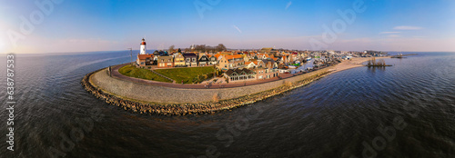 Urk Flevoland Netherlands sunset at the lighthouse and harbor of Urk Holland. Traditional Fishing Village Urk. Beautiful sunset during the evening, drone aerial view photo