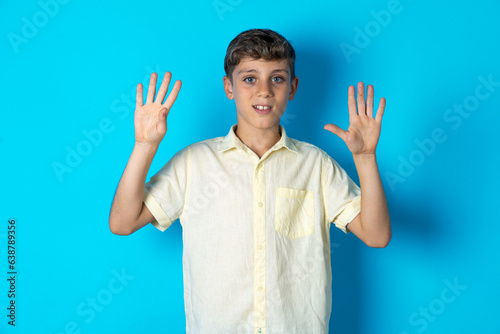 Beautiful kid boy wearing casual shirt  showing and pointing up with fingers number nine while smiling confident and happy.