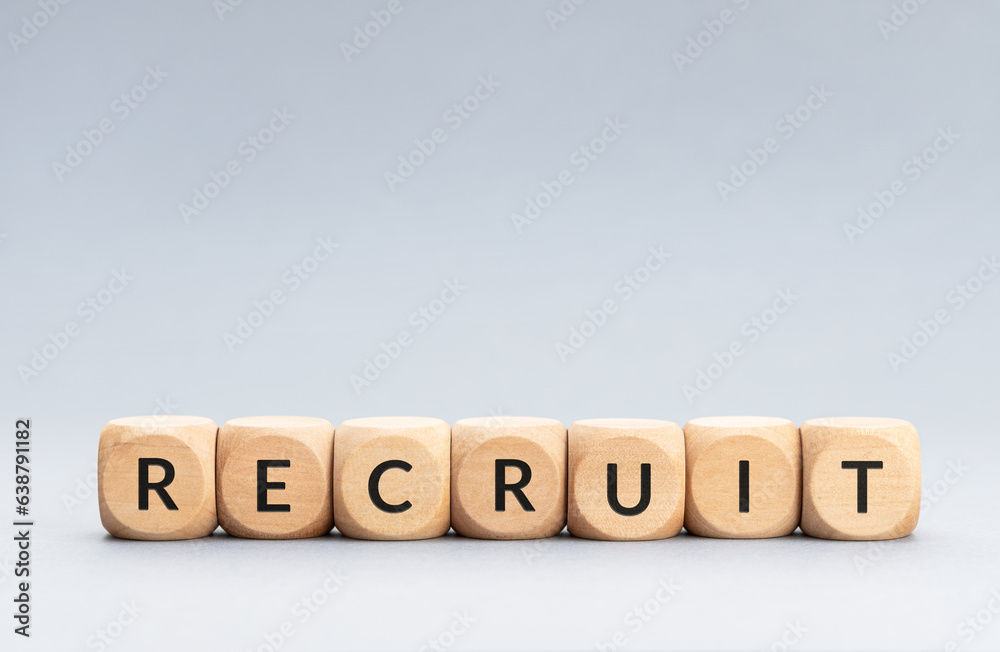 Recruit word on wooden blocks on gray background. Copy space Recruit word on wooden blocks on gray background. Copy space