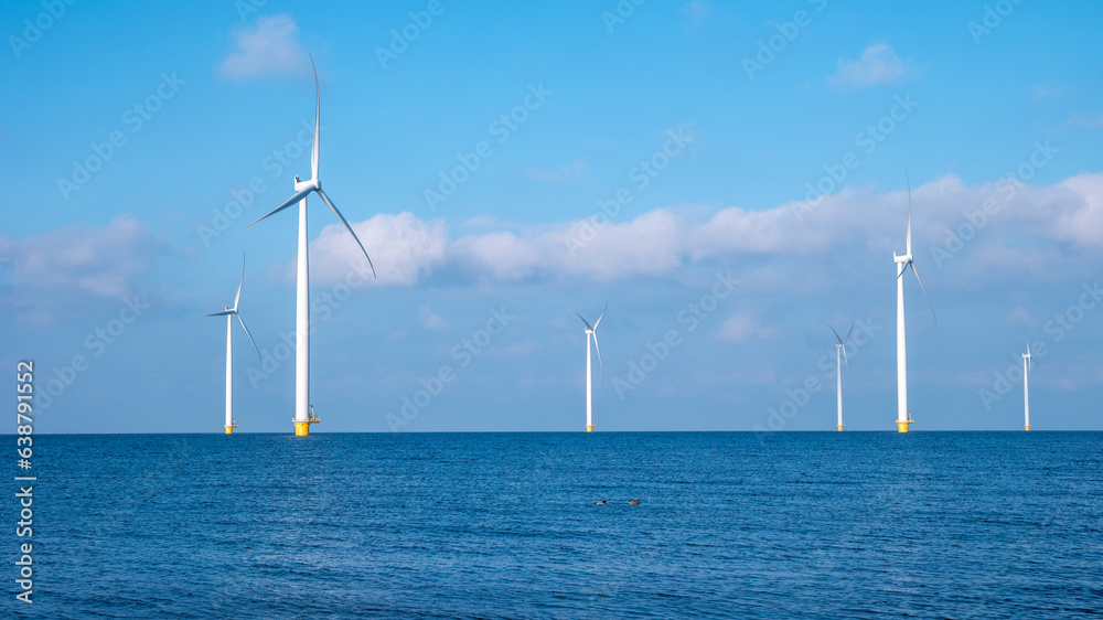windmill park with clouds and a blue sky, windmill park in the ocean aerial view with wind turbine Flevoland Netherlands Ijsselmeer. Green energy 