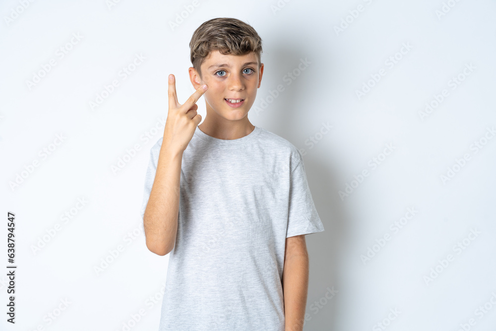 Beautiful kid boy wearing grey casual t-shirt smiling and looking friendly, showing number two or second with hand forward, counting down Beautiful kid boy wearing grey casual t-shirt smiling and looking friendly, showing number two or second with hand forward, counting down