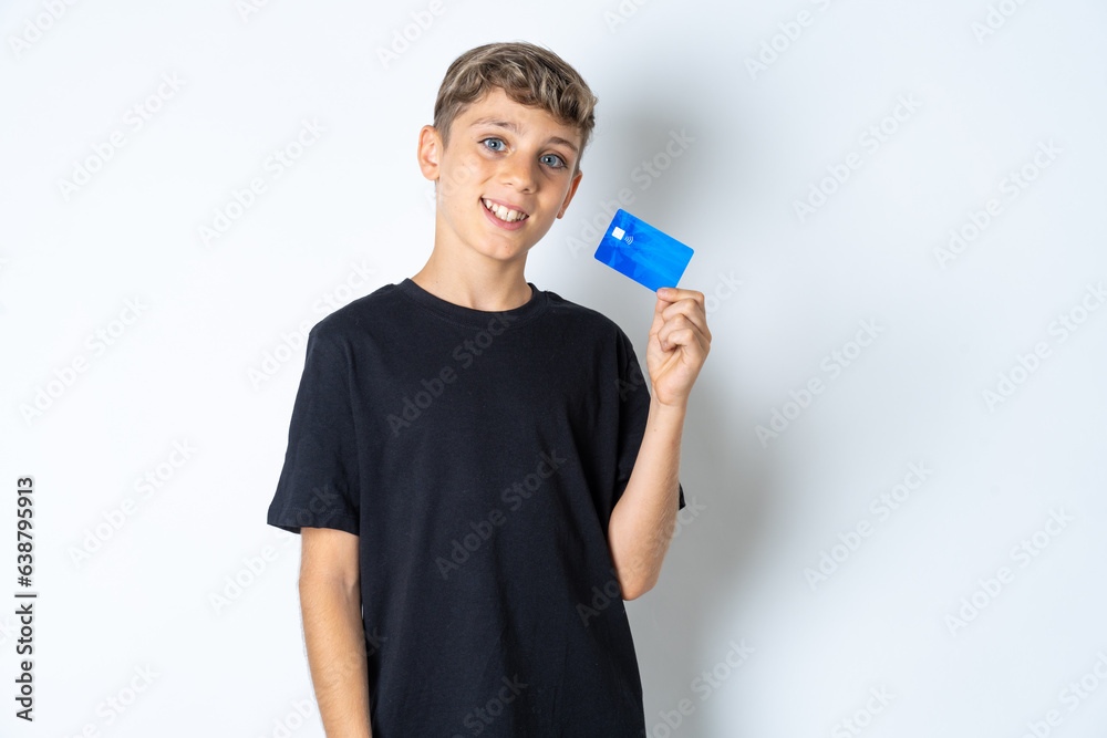 Close up photo of optimistic Beautiful kid boy wearing black casual t-shirt hold card Close up photo of optimistic Beautiful kid boy wearing black casual t-shirt hold card